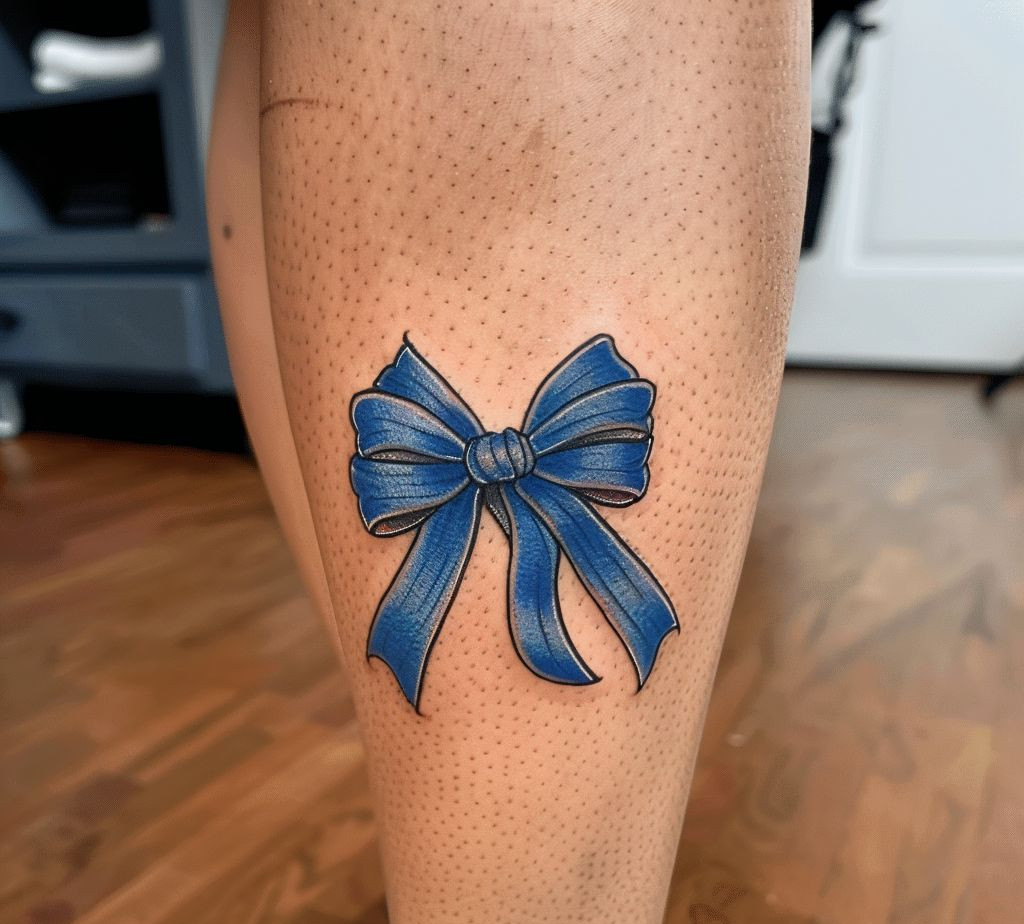 blue bow tattoo on the back leg