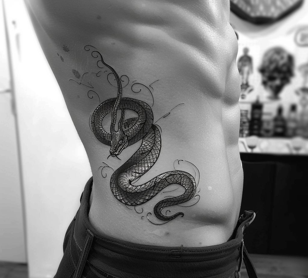 snake tattoo on the side body of a man