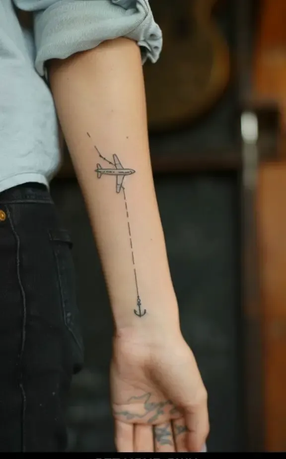 female anchor and plane tattoo