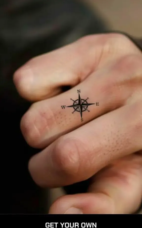 small compass tattoo  on the finger