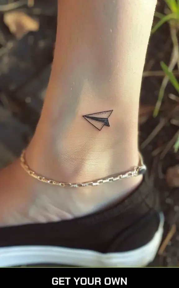 paper plane ankle tattoo