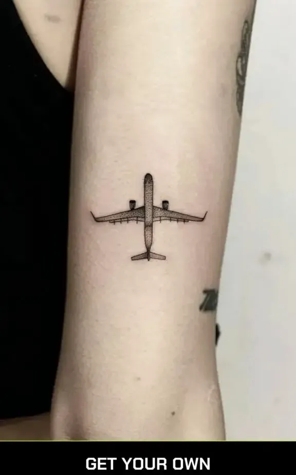 minimalist airplane tattoo on the arm