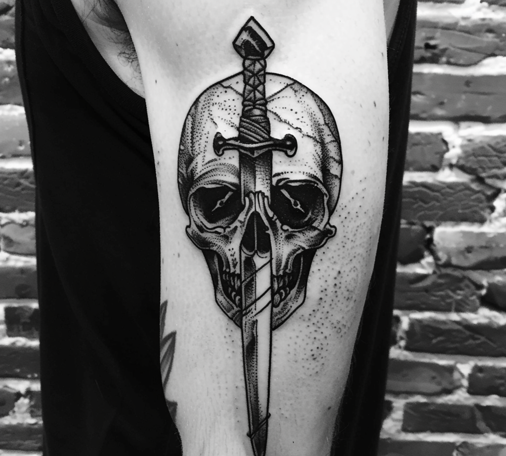 dagger pierced through a skull tattoo