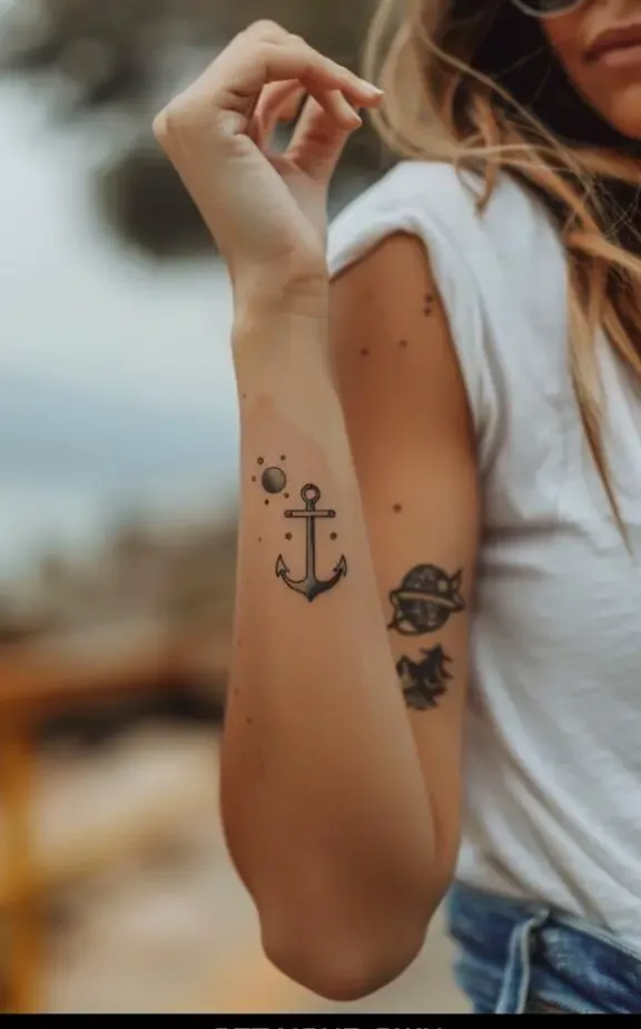 small anchor and planet tattoo